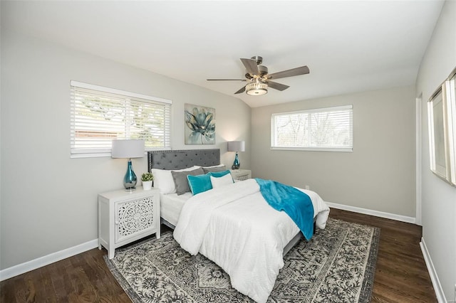 bedroom featuring baseboards, wood finished floors, and a ceiling fan