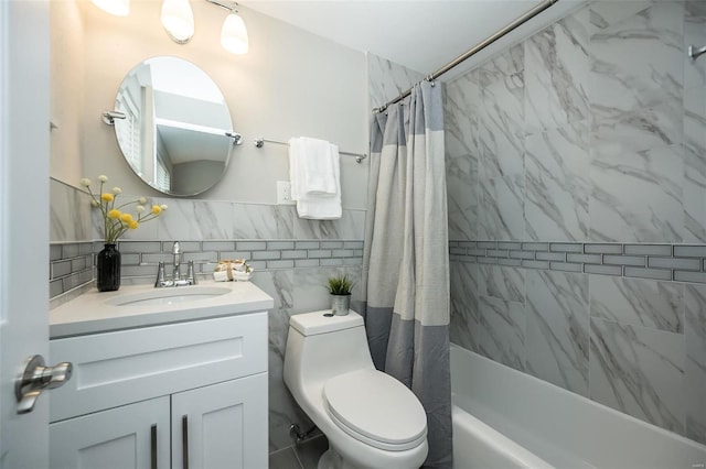 full bathroom featuring shower / bath combo with shower curtain, toilet, tile walls, and vanity