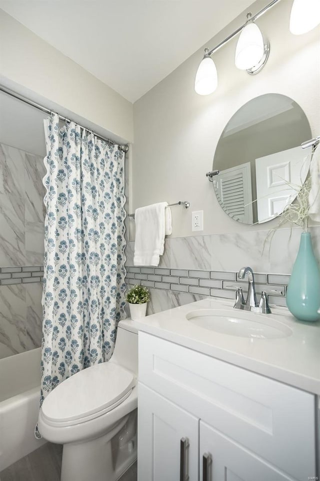 bathroom featuring toilet, tile walls, vanity, and shower / bath combo