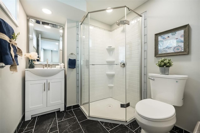 bathroom featuring marble finish floor, a stall shower, toilet, and vanity