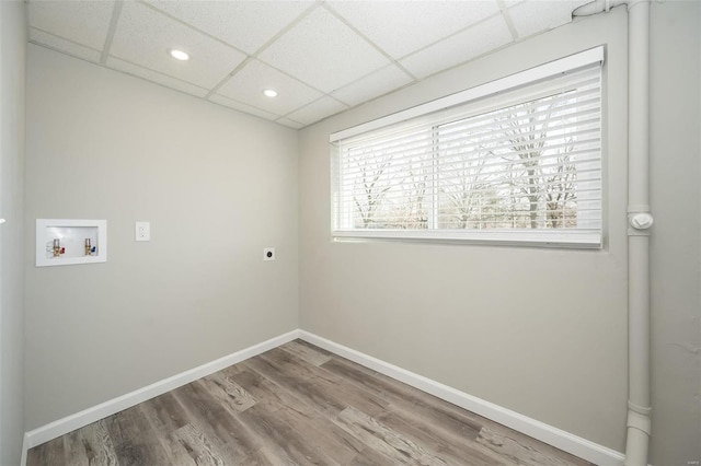 laundry area featuring wood finished floors, baseboards, hookup for an electric dryer, laundry area, and washer hookup