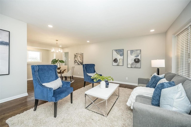 living area with recessed lighting, baseboards, and wood finished floors