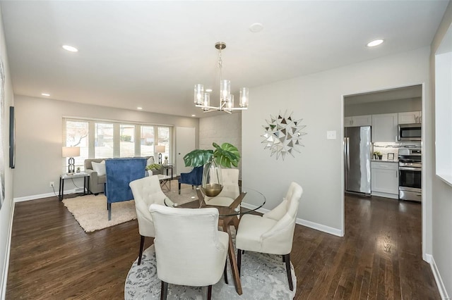 dining room with dark wood finished floors, an inviting chandelier, recessed lighting, and baseboards