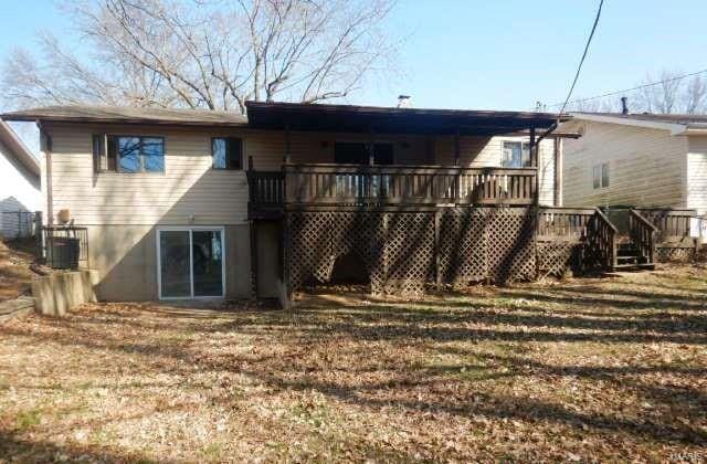 rear view of property featuring a deck