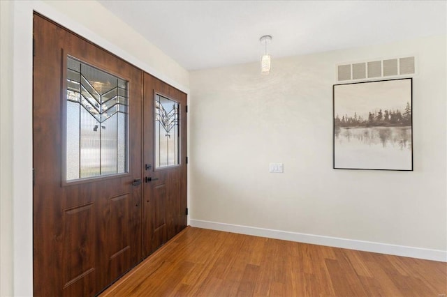 entrance foyer with light wood-style flooring, baseboards, and visible vents