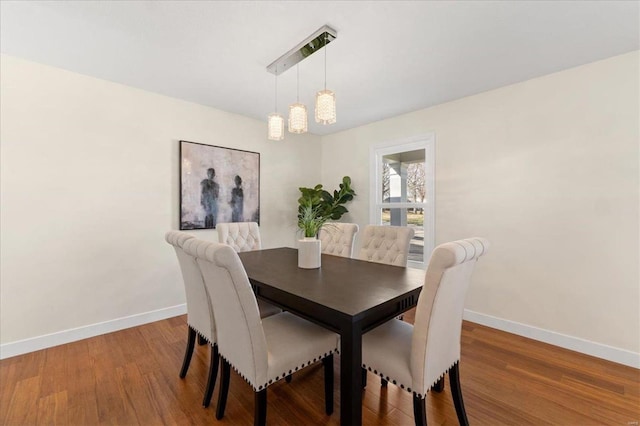 dining area featuring baseboards and wood finished floors