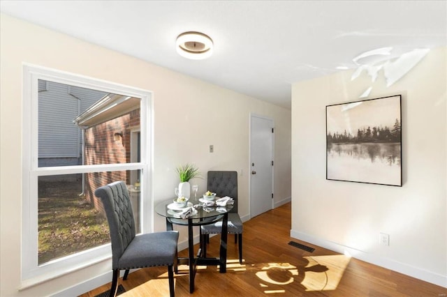 sitting room featuring visible vents, baseboards, and wood finished floors