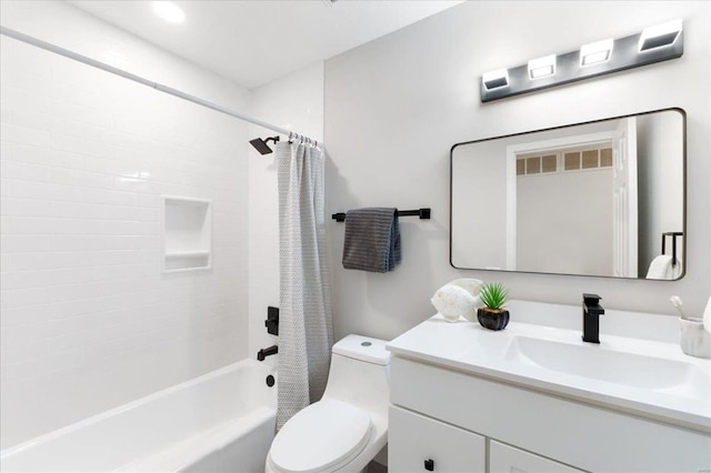 bathroom featuring vanity, shower / tub combo, and toilet