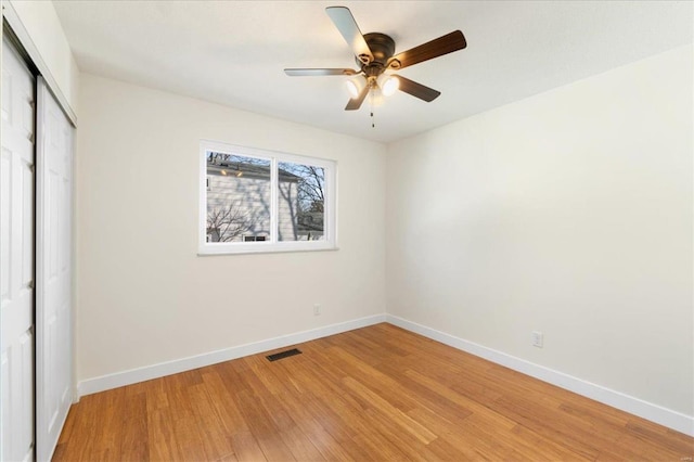 unfurnished bedroom with visible vents, baseboards, a closet, and light wood-type flooring