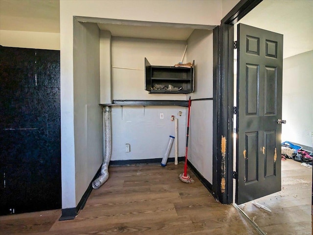 interior space with baseboards and wood finished floors