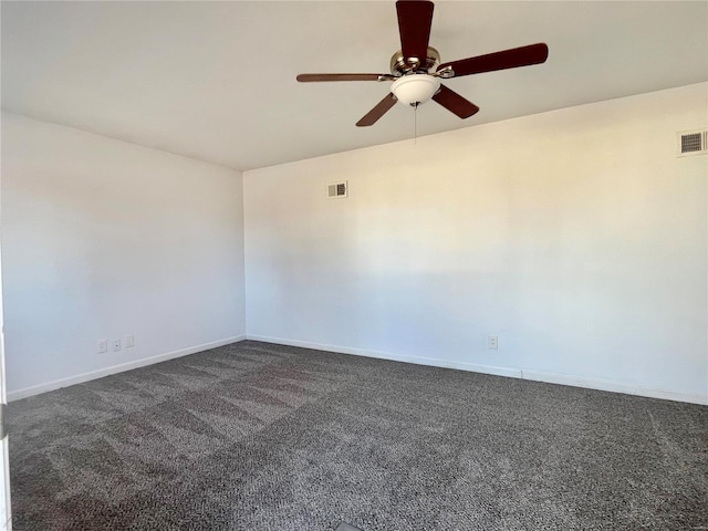 spare room with visible vents, baseboards, a ceiling fan, and dark carpet