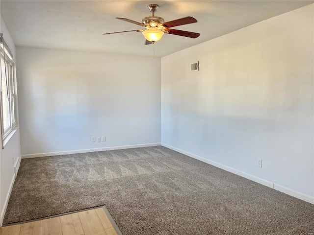 unfurnished room featuring visible vents, ceiling fan, carpet flooring, and baseboards