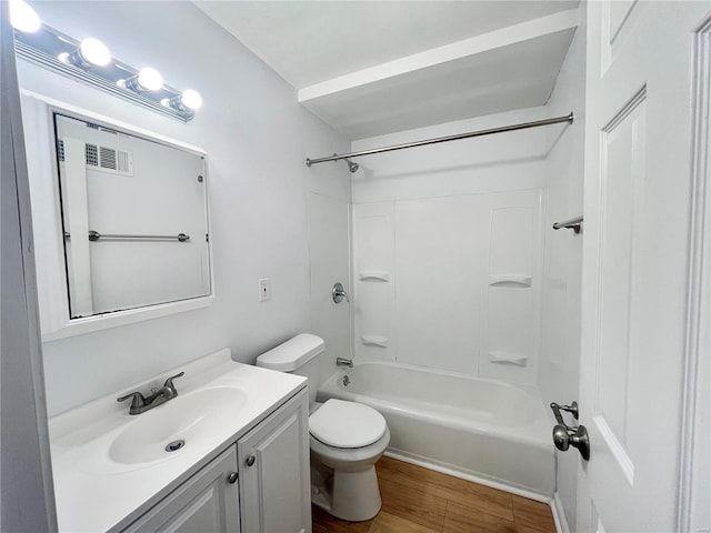 full bathroom with visible vents, toilet, shower / washtub combination, wood finished floors, and vanity