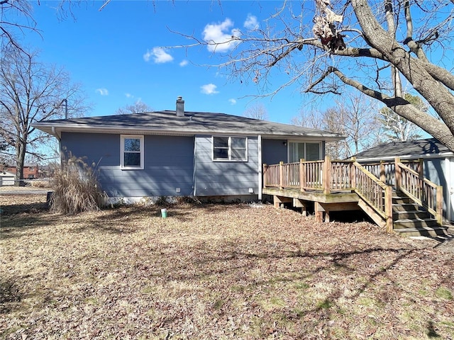 rear view of property featuring a wooden deck and a chimney