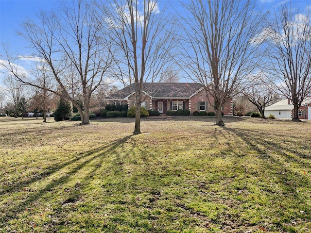 single story home featuring brick siding and a front yard