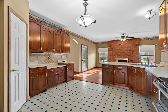 kitchen featuring ceiling fan, stainless steel appliances, a wealth of natural light, and a sink