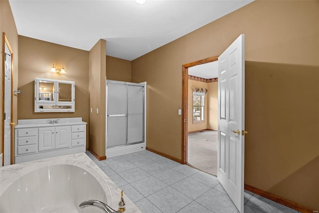 full bathroom with vanity, baseboards, tile patterned flooring, a shower stall, and a garden tub