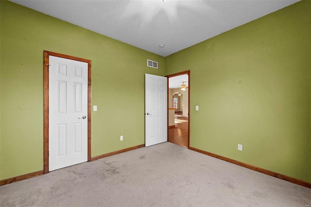 unfurnished bedroom with visible vents, baseboards, and carpet flooring