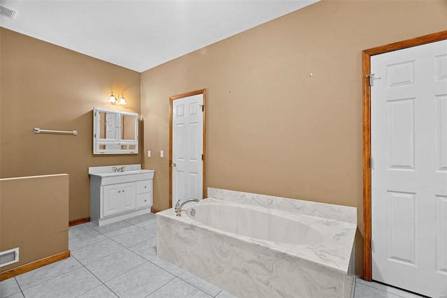 full bath featuring visible vents, a garden tub, tile patterned flooring, baseboards, and vanity