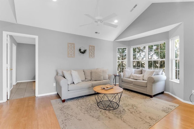 living area with visible vents, baseboards, and wood finished floors