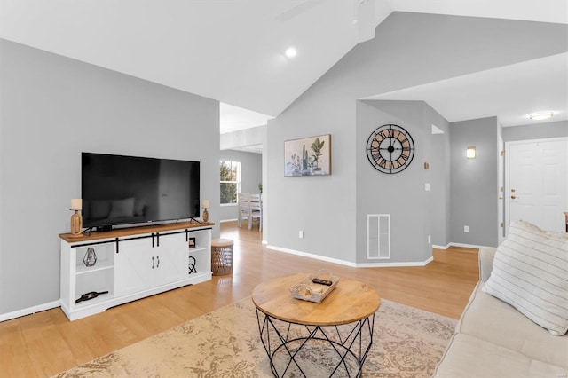 living area featuring light wood-style flooring, baseboards, visible vents, and high vaulted ceiling