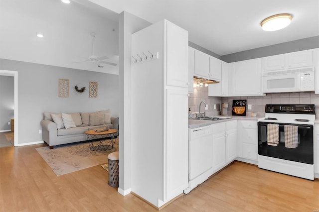 kitchen featuring white appliances, light countertops, light wood-style floors, and a sink