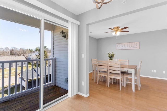 dining space featuring ceiling fan, baseboards, and wood finished floors