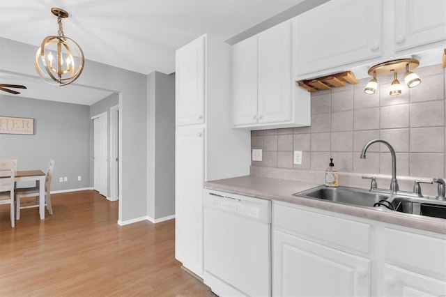 kitchen featuring ceiling fan, decorative backsplash, light countertops, a sink, and dishwasher