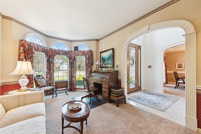 living area with tile patterned flooring, crown molding, baseboards, carpet floors, and arched walkways