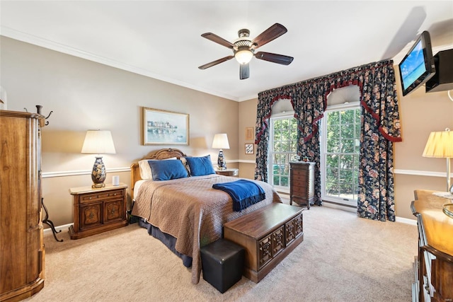 bedroom featuring carpet flooring, a ceiling fan, baseboards, and ornamental molding