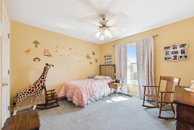 carpeted bedroom featuring baseboards and ceiling fan