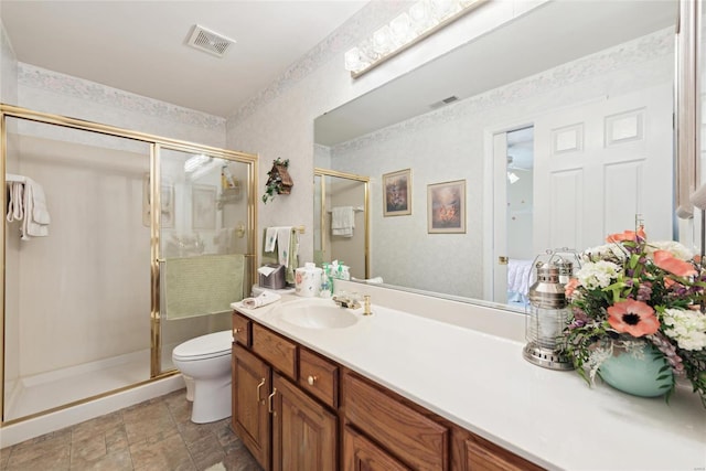 bathroom featuring vanity, visible vents, a skylight, a stall shower, and toilet