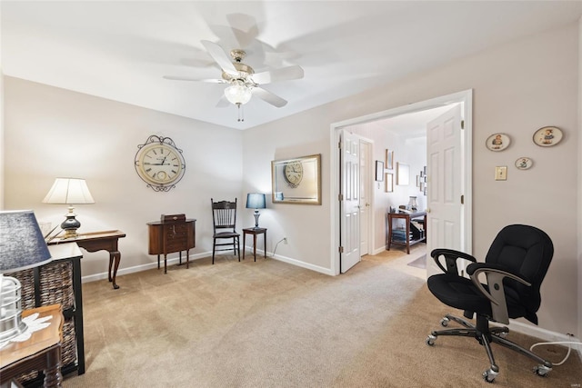 living area with a ceiling fan, light colored carpet, and baseboards