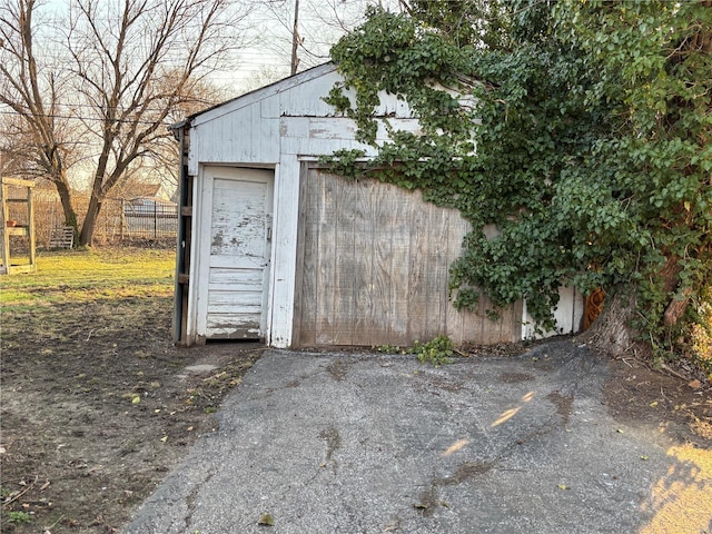 view of outbuilding featuring an outdoor structure and fence