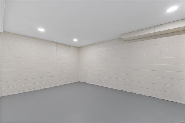 finished basement featuring recessed lighting and concrete block wall