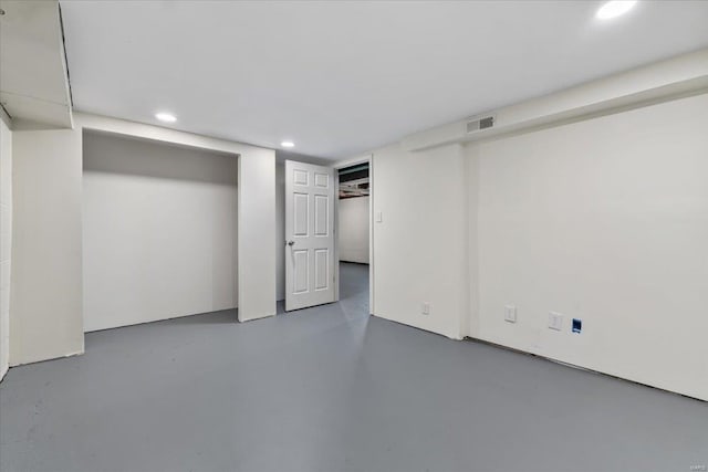 finished basement with recessed lighting and visible vents