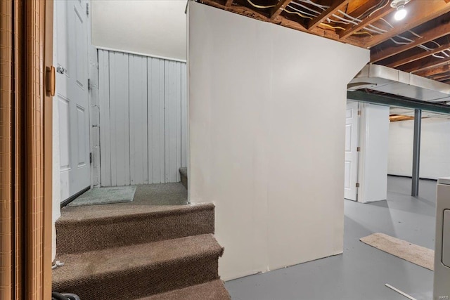 stairs featuring concrete flooring