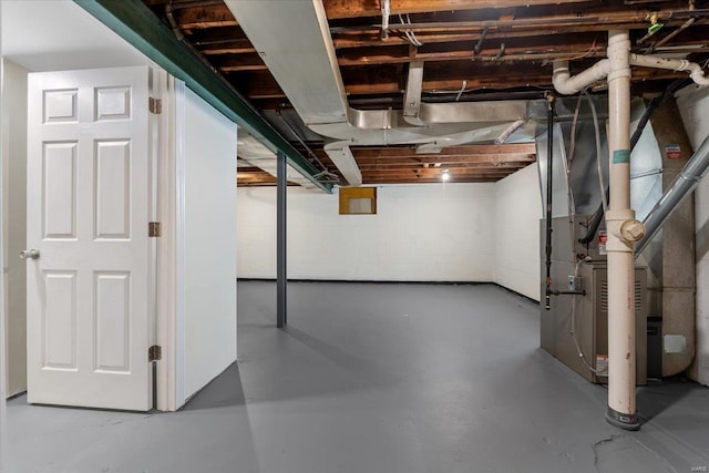 unfinished basement with heating unit and concrete block wall