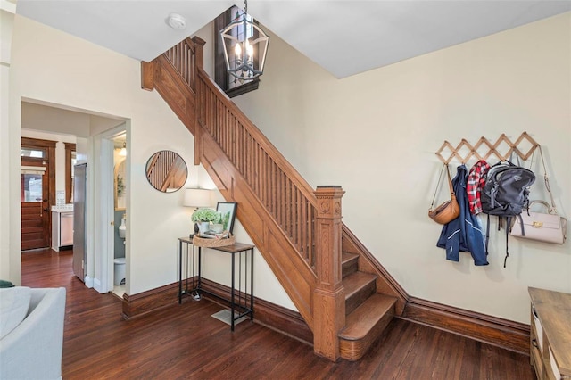 stairway with wood finished floors and baseboards