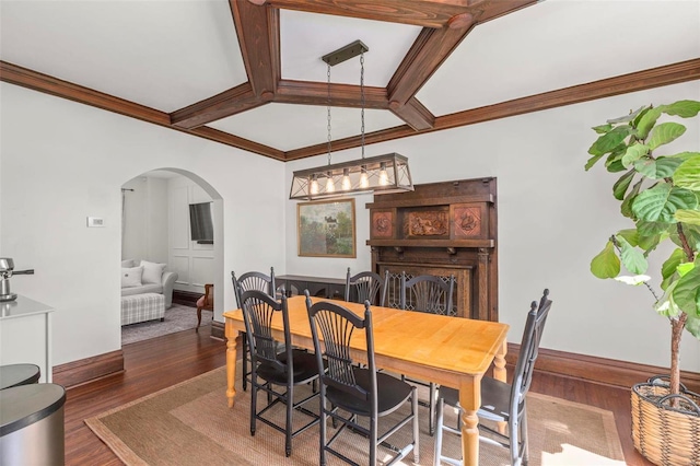 dining space with crown molding, baseboards, beam ceiling, wood finished floors, and arched walkways