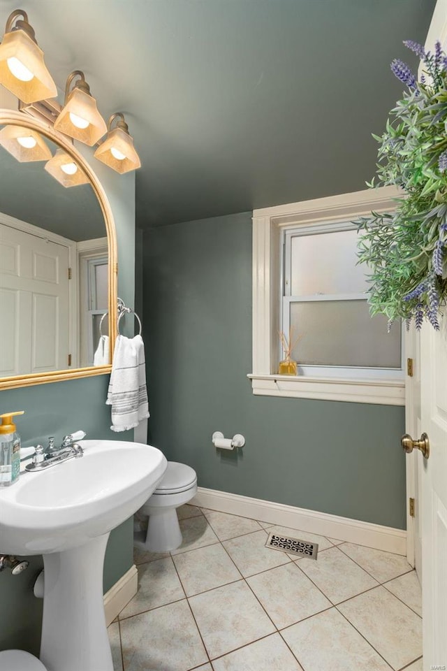 bathroom featuring tile patterned flooring, toilet, baseboards, and visible vents