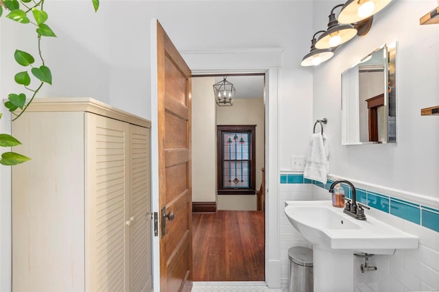 bathroom with a wainscoted wall and tile walls