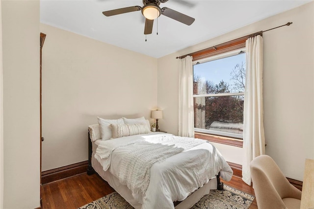 bedroom featuring ceiling fan, baseboards, and dark wood-style floors