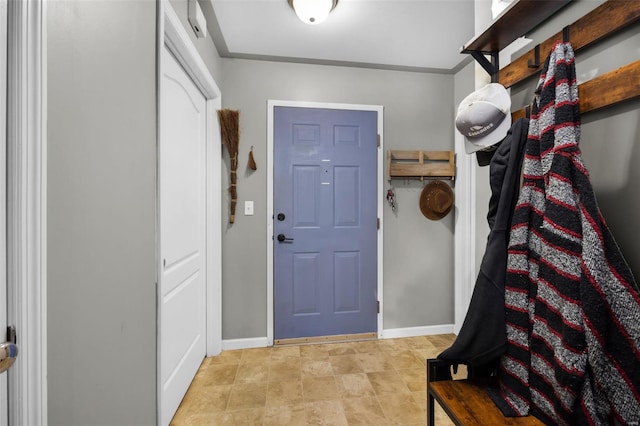 entrance foyer featuring baseboards and crown molding