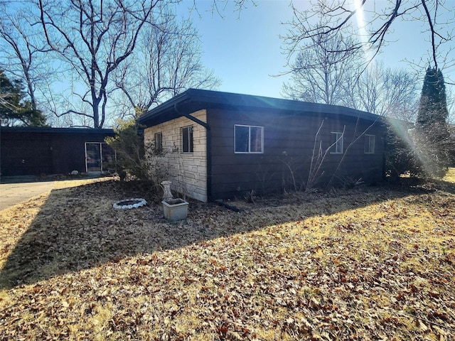 view of side of property with stone siding