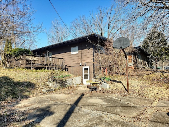 view of side of home featuring a wooden deck