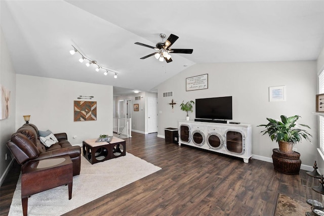 living area with visible vents, baseboards, dark wood finished floors, vaulted ceiling, and a ceiling fan