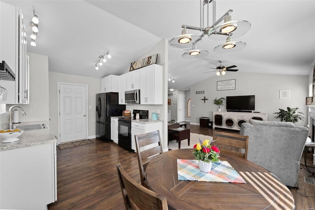 dining area featuring baseboards, dark wood finished floors, lofted ceiling, ceiling fan, and rail lighting