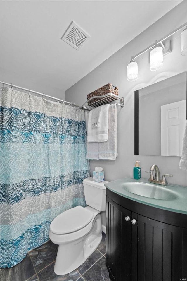 bathroom featuring visible vents, curtained shower, toilet, and vanity