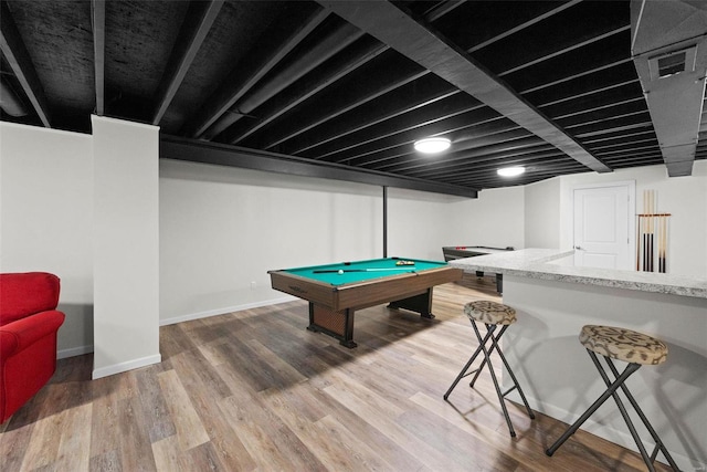 recreation room with wood finished floors and baseboards